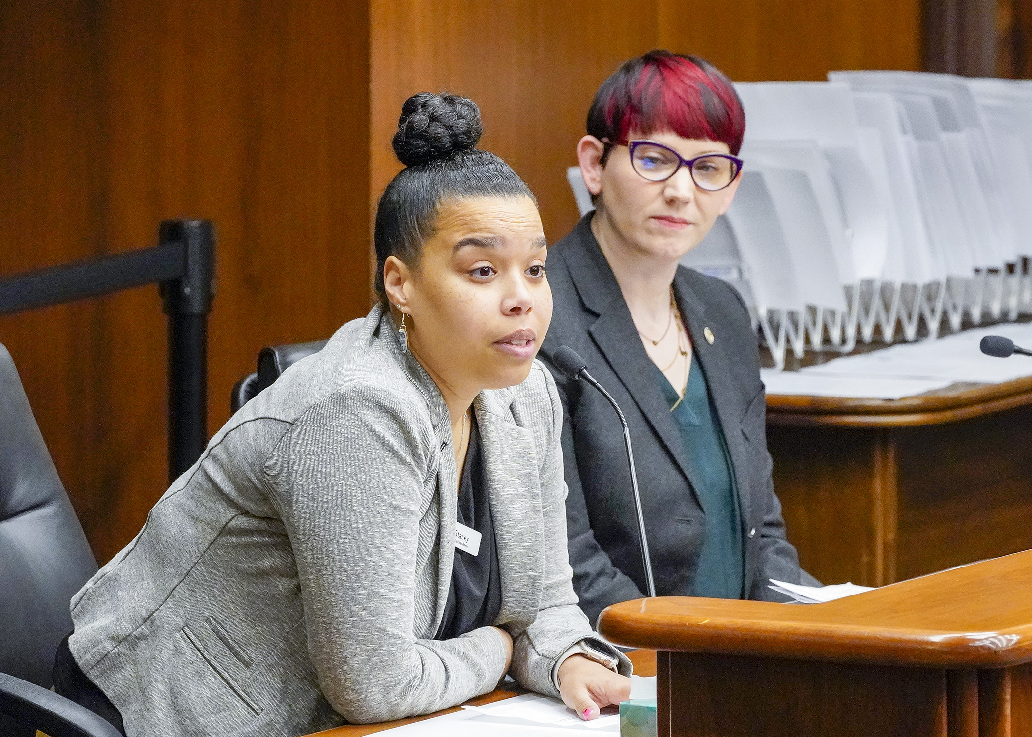 Stacey Guilfoyle Collier, a director at the Youth Intervention Programs Association, testifies before the House Public Safety Finance and Policy Committee Feb. 9 in support of a bill sponsored by Rep. Sandra Feist, right, to provide program funding. (Photo by Andrew VonBank)